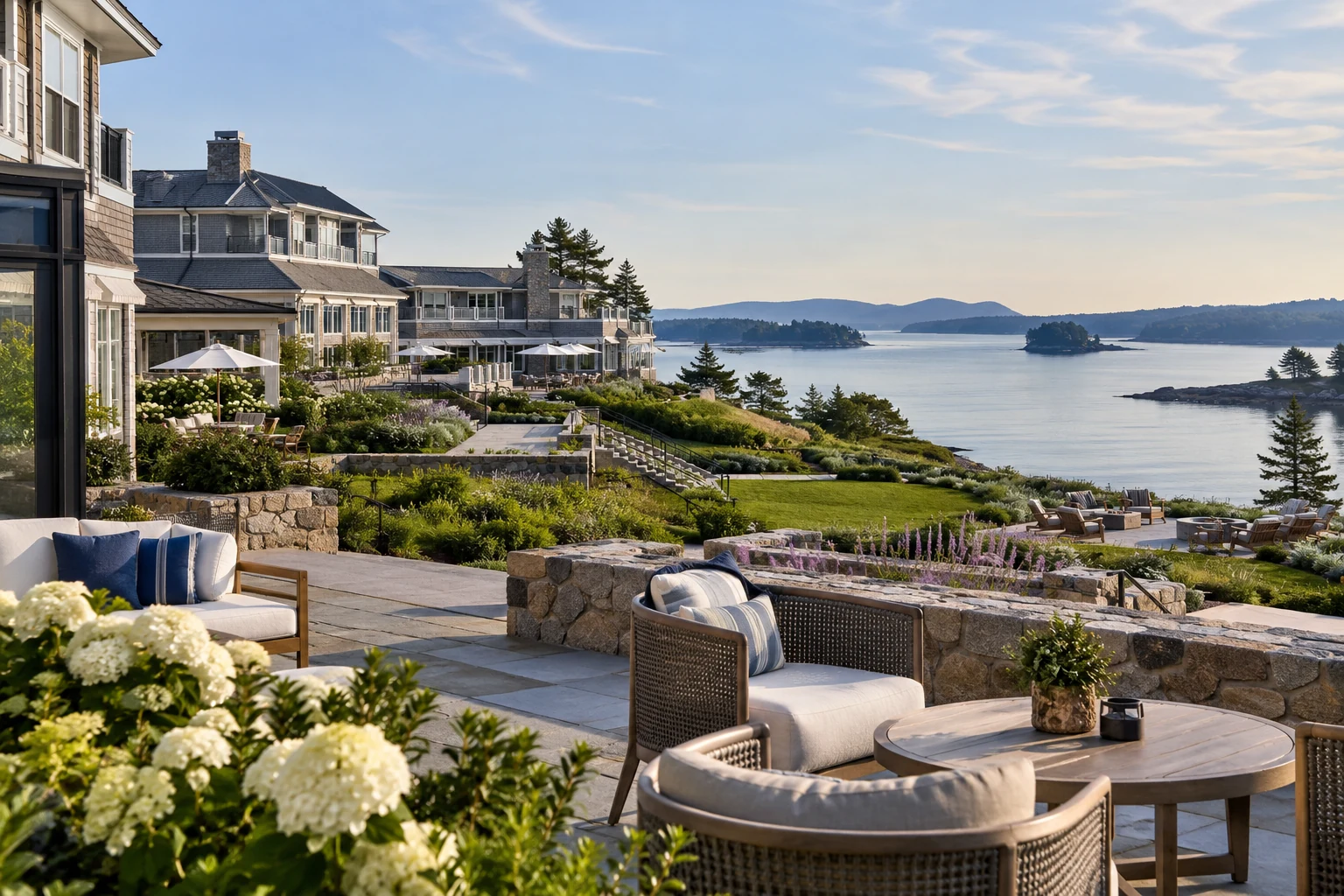 Waterfront resort buildings and landscaped terraces overlooking calm water